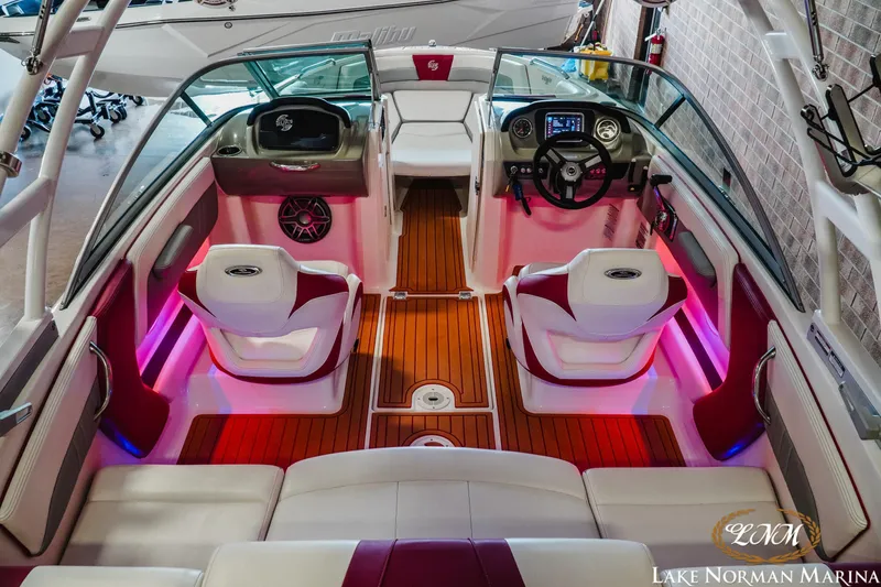Slide: The Image of 2018 Chaparral 21 Surf boat interior with stylish seating and vibrant lighting. - 8