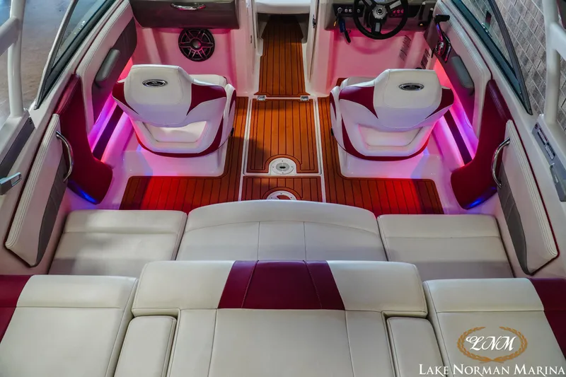 Slide: The Image of 2018 Chaparral 21 Surf boat interior with red accents and ambient lighting. - 9