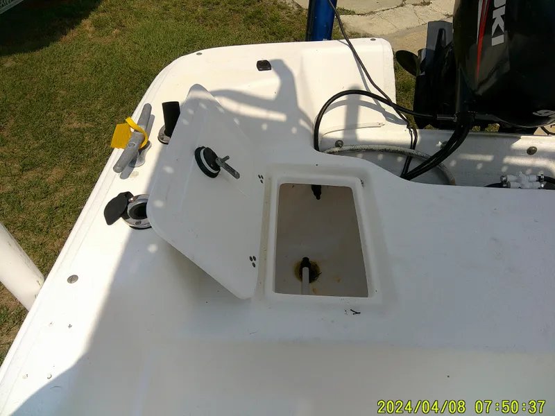 Slide: The Image of 2010 Carolina Skiff 198 DLV boat deck with open hatch and motor. - 13