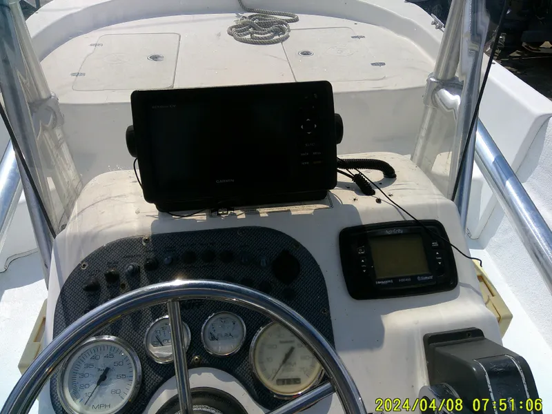 Slide: The Image of 2010 Carolina Skiff 198 DLV boat dashboard with steering wheel and navigation equipment. - 15