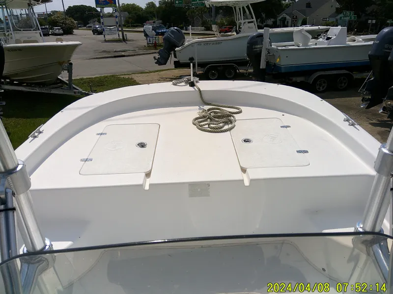 Slide: The Image of 2010 Carolina Skiff 198 DLV boat deck with storage compartments and rope. - 16