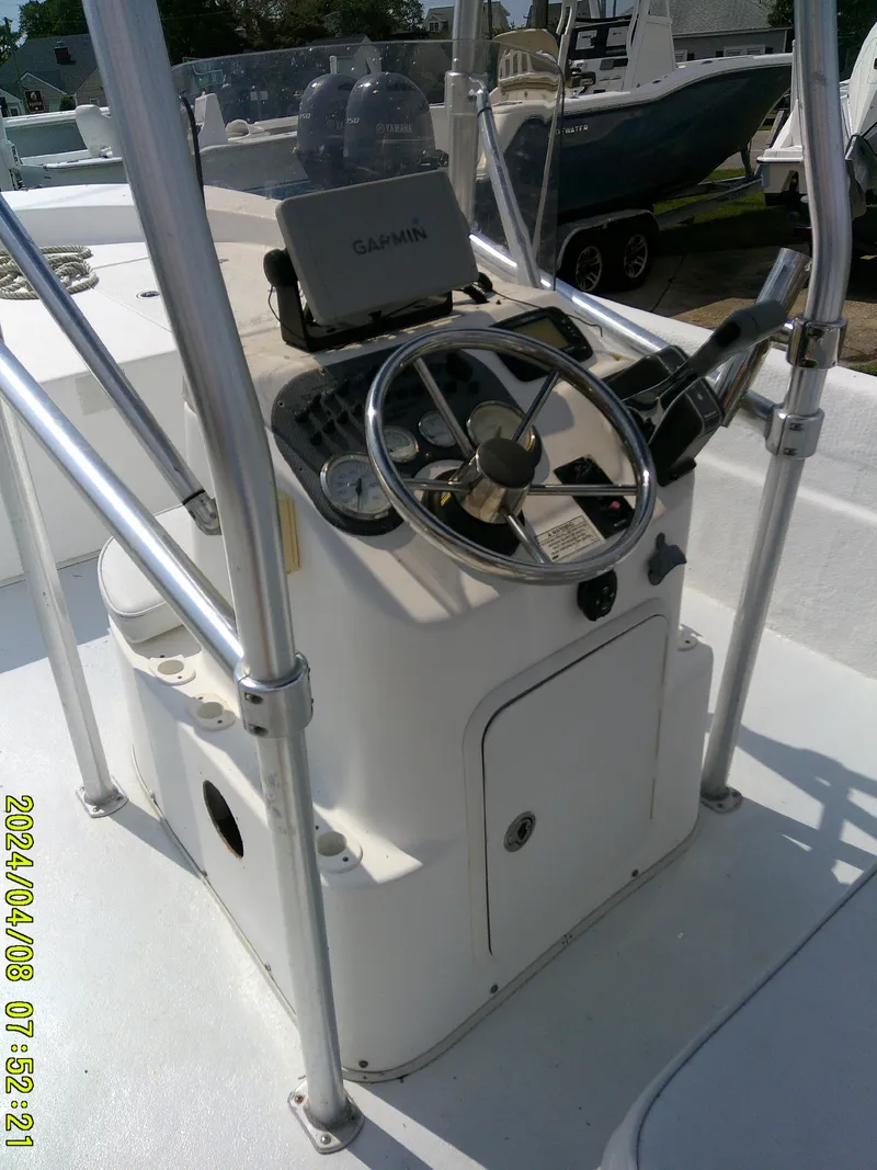 Slide: The Image of 2010 Carolina Skiff 198 DLV boat console with steering wheel and navigation equipment. - 17