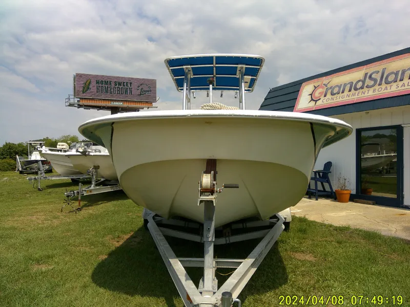 Slide: The Image of 2010 Carolina Skiff 198 DLV boat on trailer at dealership, sunny day. - 3
