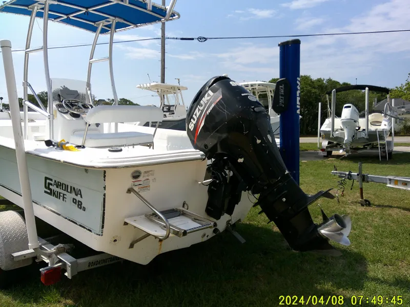 Slide: The Image of 2010 Carolina Skiff 198 DLV boat with Suzuki outboard motor on trailer. - 6