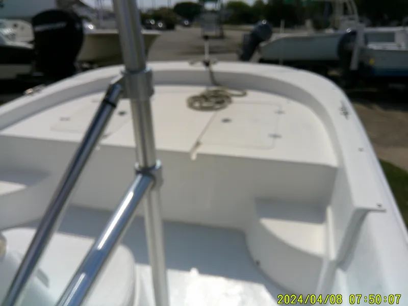 Slide: The Image of 2010 Carolina Skiff 198 DLV boat interior with seating and deck view. - 8