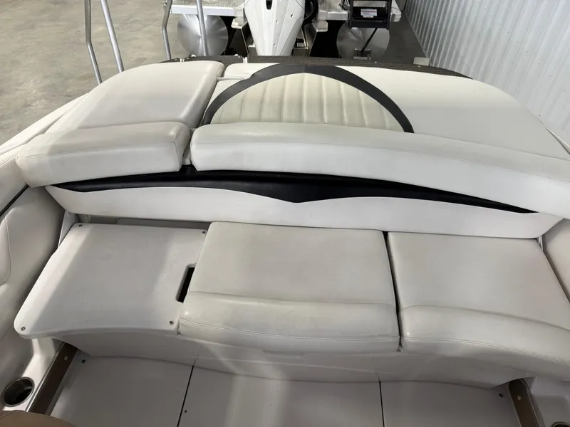 Slide: The Image of 2009 Four Winns H200 boat interior with white cushioned seating. - 10