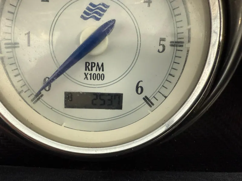 Slide: The Image of Close-up of a 2009 Four Winns H200 RPM gauge showing 253.7 hours. - 14