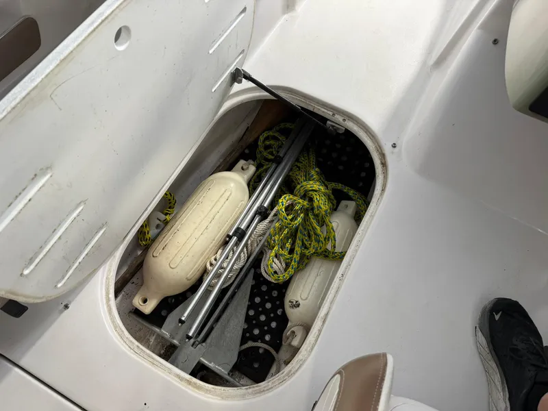Slide: The Image of Storage compartment in a 2009 Four Winns H200 boat with ropes and fenders. - 15