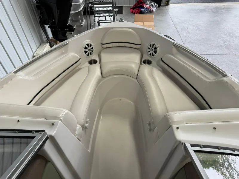 Slide: The Image of 2009 Four Winns H200 boat interior with beige seating and cup holders. - 16