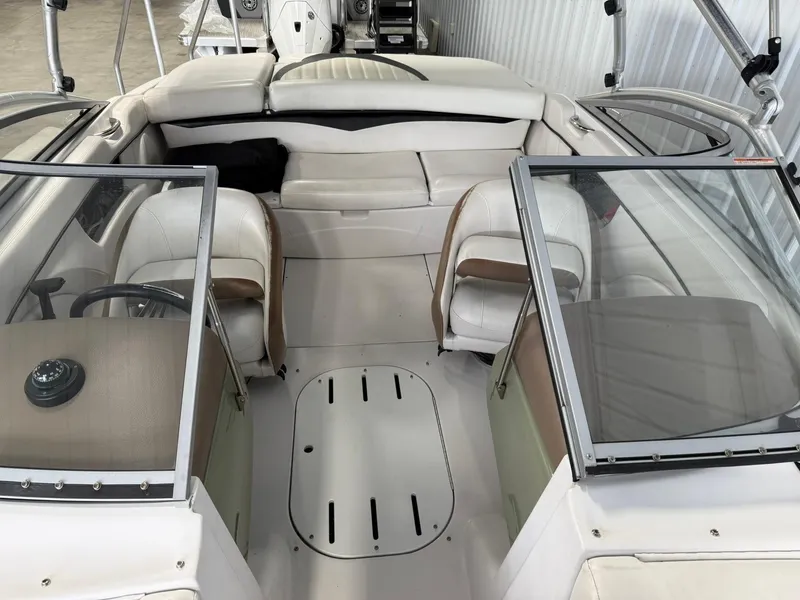 Slide: The Image of 2009 Four Winns H200 boat interior with white seating and dual consoles. - 17