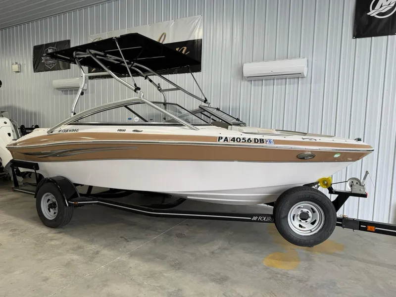 Slide: The Image of 2009 Four Winns H200 boat on trailer in indoor storage. - 3