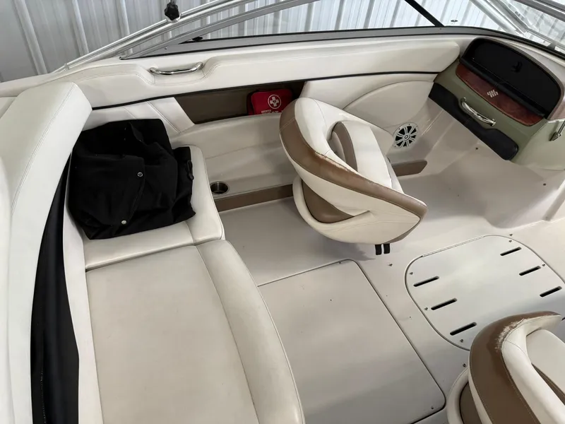 Slide: The Image of 2009 Four Winns H200 boat interior with white seating and dashboard. - 9