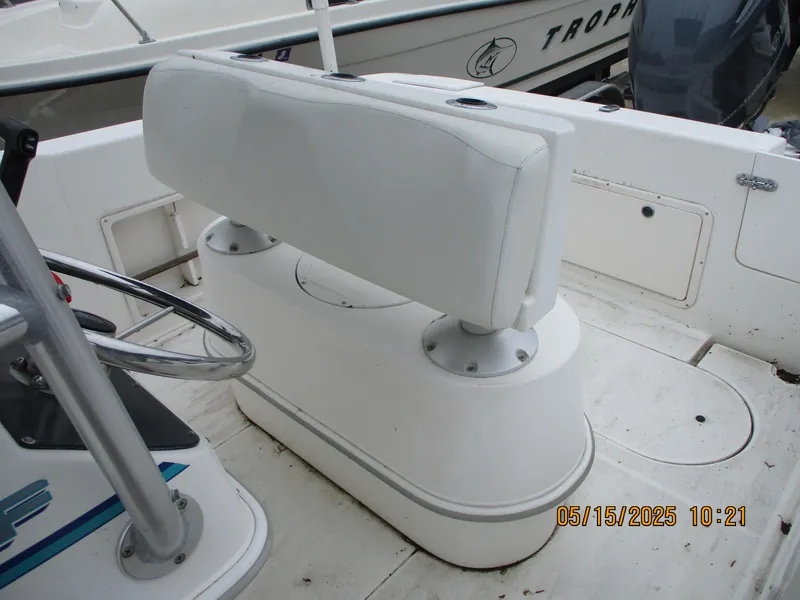 Slide: The Image of 1995 Wellcraft 218ccf boat interior with white seating and steering wheel. - 11