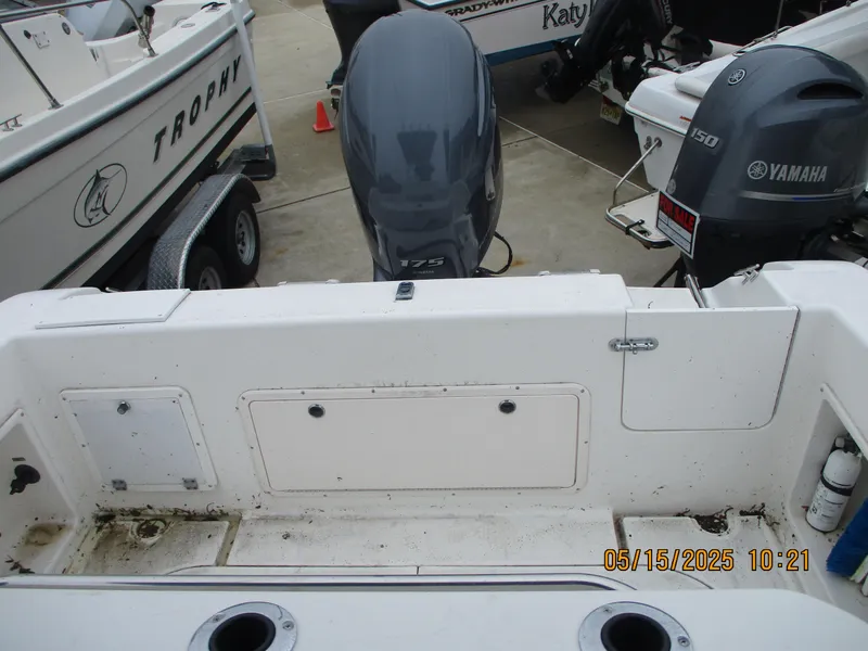 Slide: The Image of 1995 Wellcraft 218ccf boat with Yamaha outboard engines, docked alongside other boats. - 12