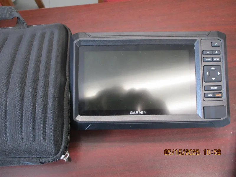 Slide: The Image of Garmin GPS device with protective case on wooden surface, dated May 15, 2025. - 2