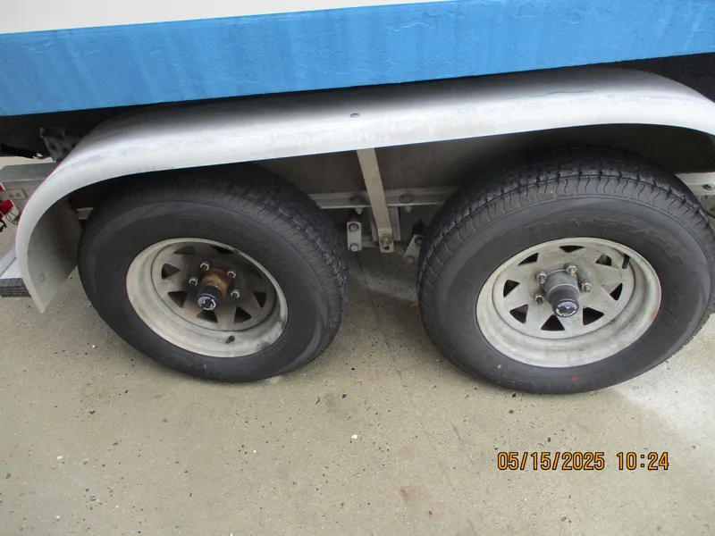 Slide: The Image of Trailer wheels of a 1995 Wellcraft 218ccf boat, dated May 15, 2025. - 21