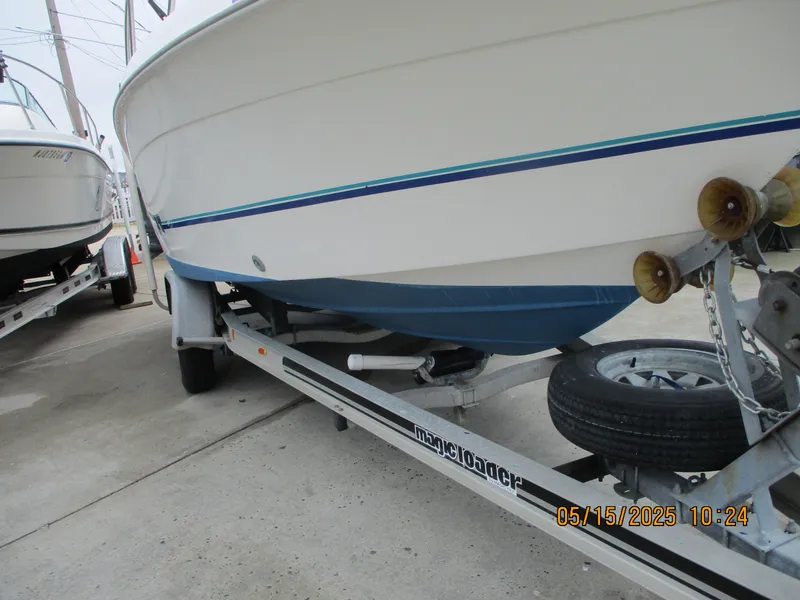 Slide: The Image of 1995 Wellcraft 218ccf boat on trailer, side view, with blue stripe detailing. - 24