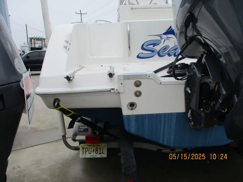 Slide: The Image of 1995 Wellcraft 218ccf boat on trailer, rear view with outboard motor. - 25