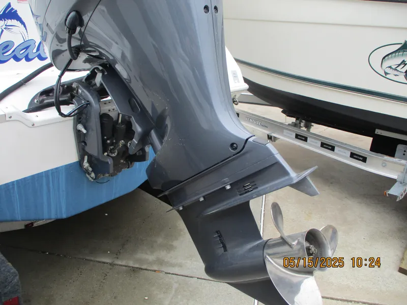 Slide: The Image of Outboard motor of a 1995 Wellcraft 218ccf boat, shown on a trailer. - 26