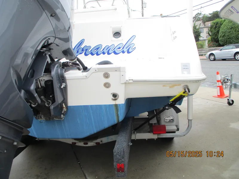 Slide: The Image of 1995 Wellcraft 218ccf boat with outboard motor, parked on a trailer. - 28