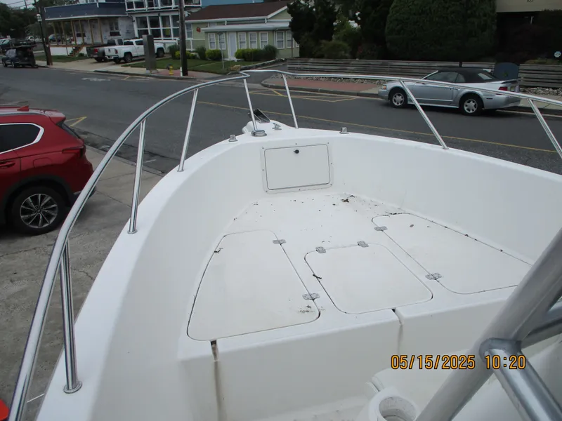Slide: The Image of 1995 Wellcraft 218ccf boat deck with railings, parked on a street. - 3
