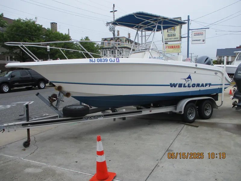Slide: The Image of 1995 Wellcraft 218ccf boat on trailer, parked outdoors with traffic cone nearby. - 4