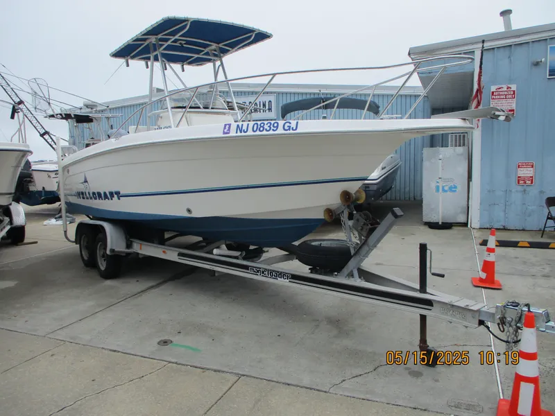 Slide: The Image of 1995 Wellcraft 218ccf boat on trailer, docked at marina, with blue canopy. - 5