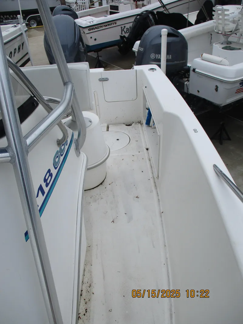 Slide: The Image of 1995 Wellcraft 218ccf boat interior with Yamaha engine, docked alongside other boats. - 9