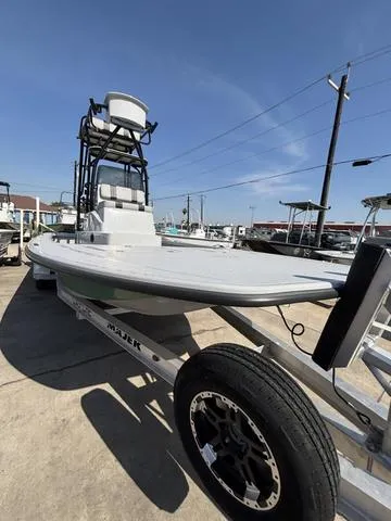 Slide: The Image of 2024 Majek 24 Reaper boat on trailer, displayed outdoors under clear blue sky. - 3