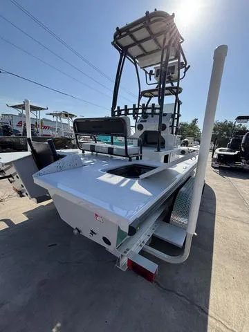 Slide: The Image of 2024 Majek 24 Reaper boat with elevated tower, parked on a sunny day. - 5