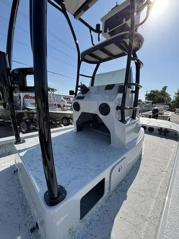 Slide: The Image of 2024 Majek 24 Reaper boat with elevated console and sleek design in a sunny outdoor setting. - 7