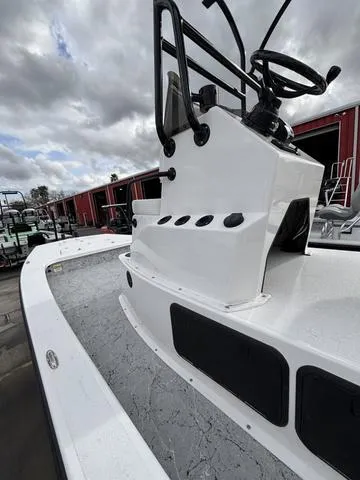 Slide: The Image of 2024 Majek 25 ILLUSION boat with sleek white design and modern controls. - 4