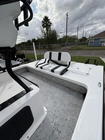 Slide: The Image of 2024 Majek 25 ILLUSION boat interior with seating, under cloudy sky. - 5