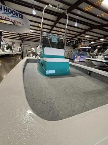 Slide: The Image of 2024 Majek 2206 Illusion boat displayed in a showroom with teal seating. - 3