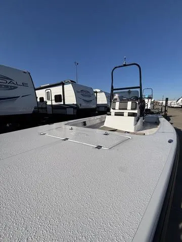 Slide: The Image of 2025 Majek M2 ILLUSION boat with sleek design, parked near RVs under clear blue sky. - 5