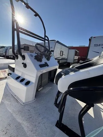 Slide: The Image of 2025 Majek M2 ILLUSION boat console with steering wheel and seating, under bright sunlight. - 7