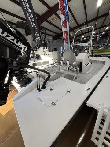 Slide: The Image of 2025 Majek 2206 Illusion boat with Suzuki engine displayed indoors. - 2