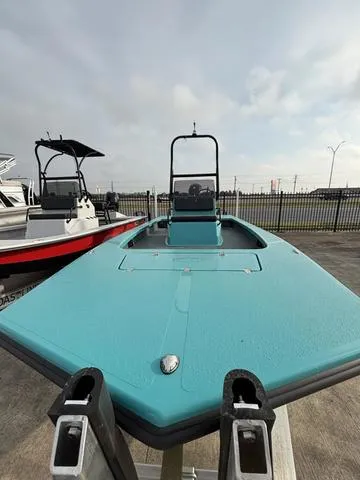 Slide: The Image of 2025 Majek 2206 Illusion boat, turquoise deck, docked outdoors, overcast sky. - 4