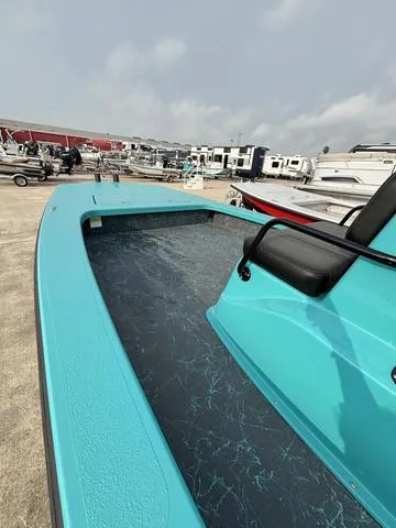 Slide: The Image of 2025 Majek 2206 Illusion boat in a marina, showcasing sleek turquoise design. - 6