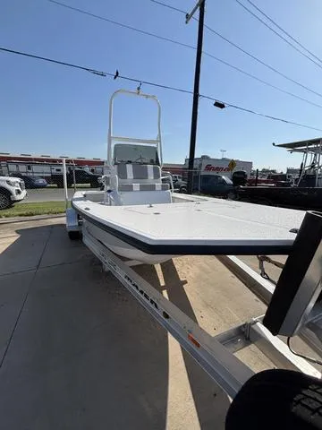 Slide: The Image of 2025 Majek 18 M2 boat on trailer, displayed outdoors under clear sky. - 2