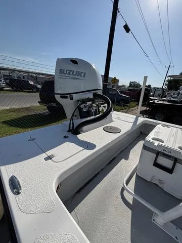 Slide: The Image of 2025 Majek 18 M2 boat with Suzuki outboard motor, parked outdoors. - 4