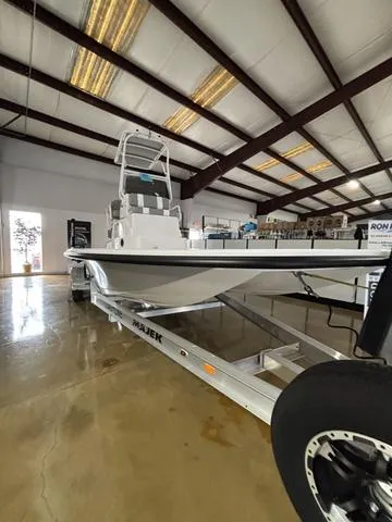 Slide: The Image of 2025 Majek 24 Reaper boat in showroom, displayed on a trailer. - 3
