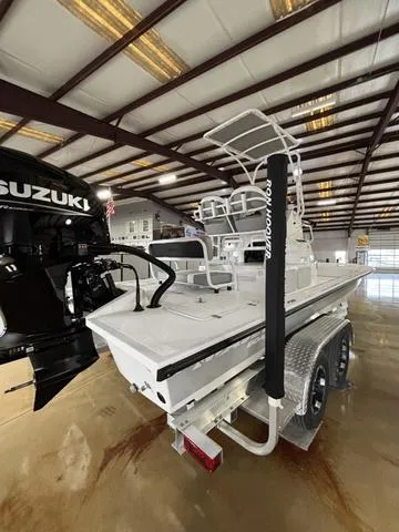 Slide: The Image of 2025 Majek 24 Reaper boat with Suzuki engine in a showroom. - 4