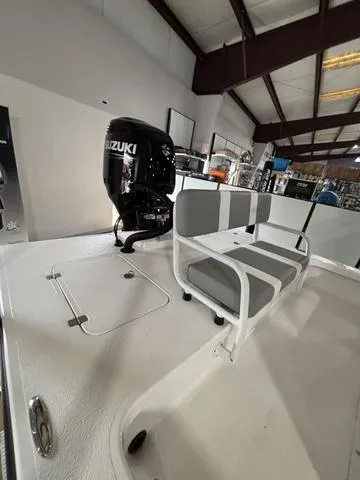 Slide: The Image of 2025 Majek 24 Reaper boat with Suzuki outboard motor in showroom. - 5