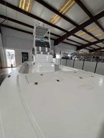 Slide: The Image of 2025 Majek 24 Reaper boat displayed indoors, showcasing sleek design and spacious deck. - 8