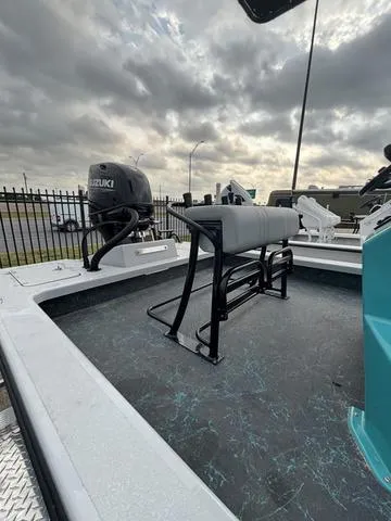 Slide: The Image of 2025 Majek 21 RFL boat with Suzuki outboard motor under cloudy sky. - 4