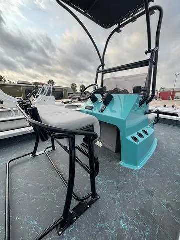 Slide: The Image of 2025 Majek 21 RFL boat with sleek console and seating, under a cloudy sky. - 5