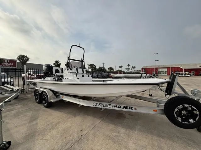Slide: The Image of 2025 Majek 2206 Illusion boat on trailer, parked outdoors, overcast sky. - 1