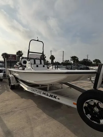 Slide: The Image of 2025 Majek 2206 Illusion boat on trailer, parked outdoors under cloudy sky. - 2