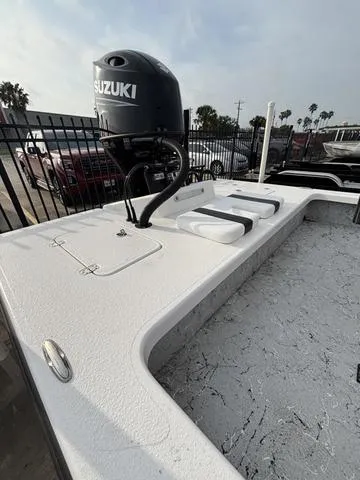 Slide: The Image of 2025 Majek 2206 Illusion boat with Suzuki outboard motor, parked outdoors. - 4